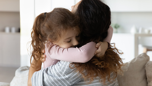 Mom hugging daugther